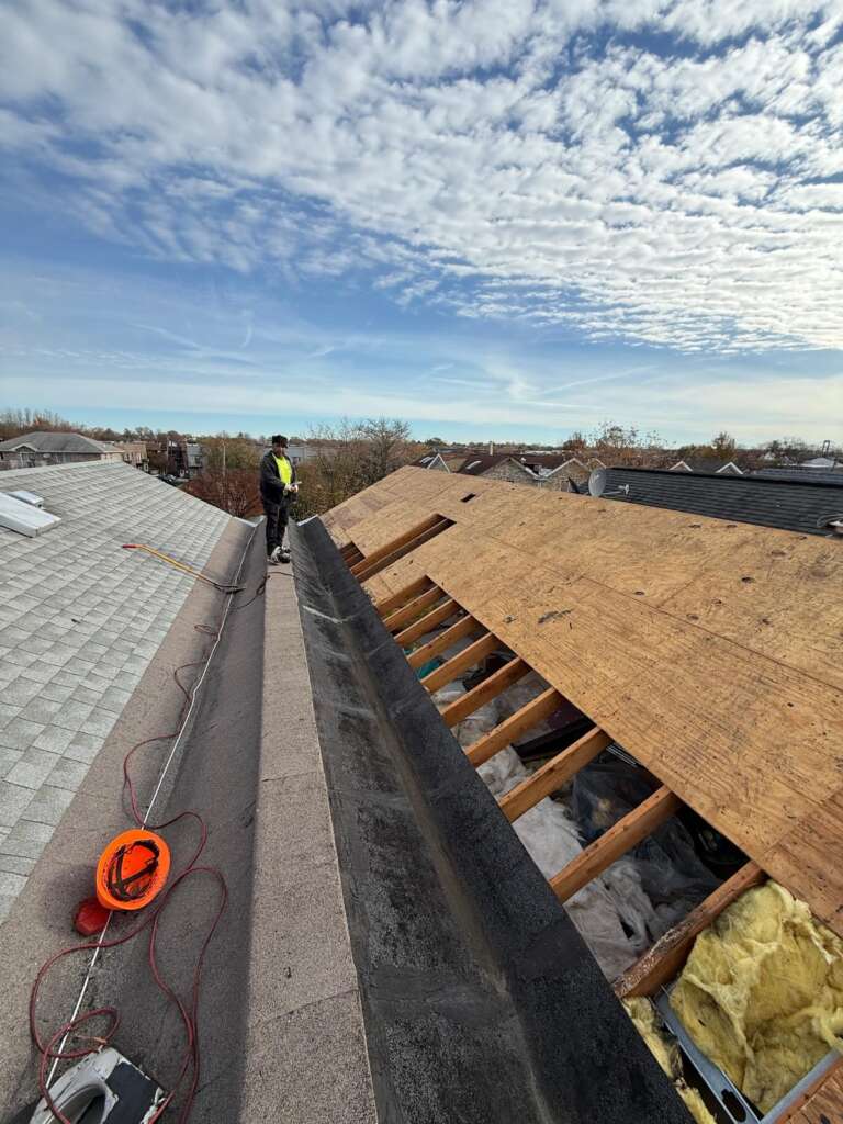Shingle roof installation in progress in Throgs Neck, Bronx. Roofing team removing old shingles, preparing roof deck, and installing underlayment for durable and long-lasting results.