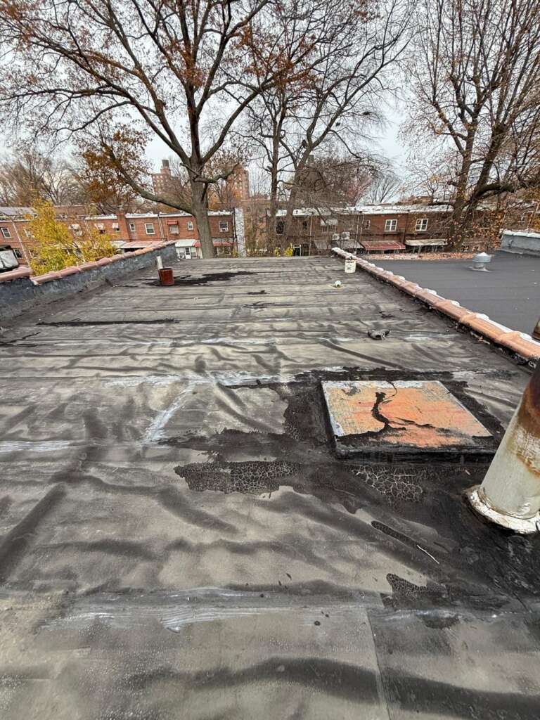 Old flat roof condition before replacement at Country Club, Bronx. Preparation for new flat roof installation by Home Team Construction.