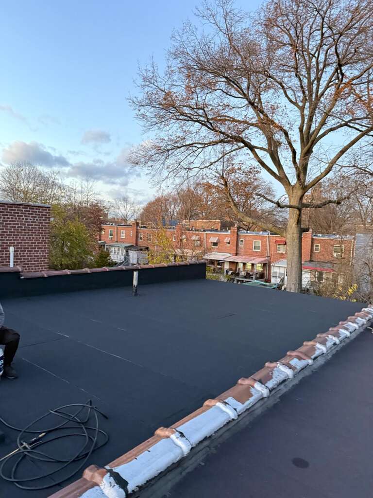 Completed flat roof replacement at Country Club, Bronx. High-quality waterproof flat roofing system installed by Home Team Construction for maximum durability and protection.