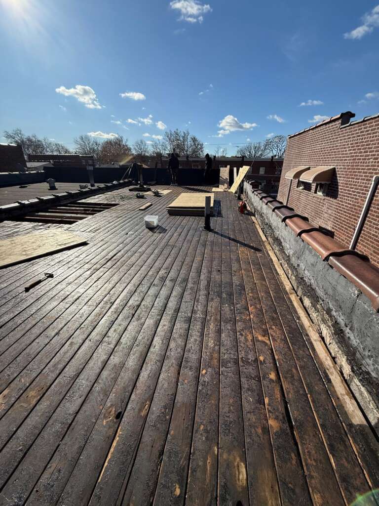 Old flat roof condition before replacement at Country Club, Bronx. Preparation for new flat roof installation by Home Team Construction.